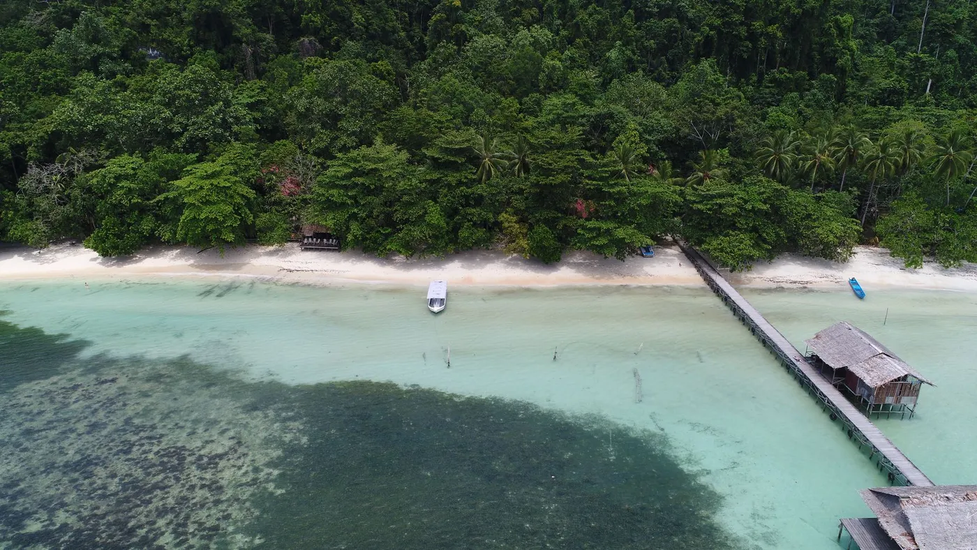 The resort jetty and white-sand beach from the air